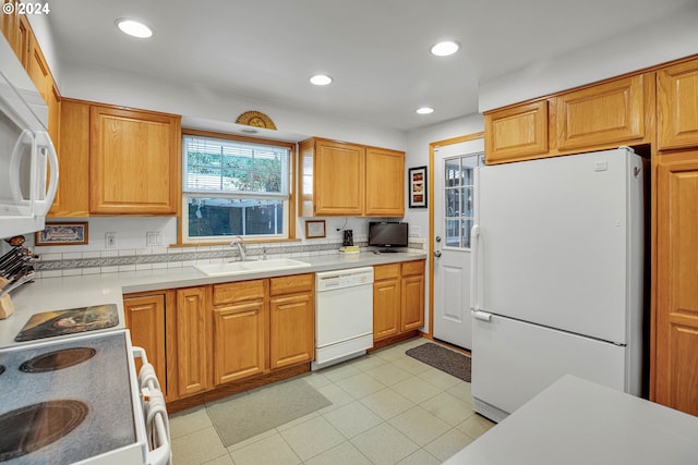 kitchen featuring white appliances and sink