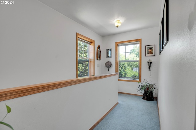 corridor featuring light colored carpet