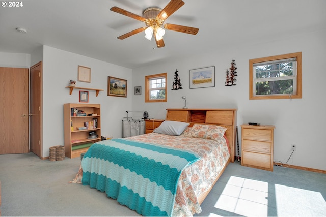 bedroom with ceiling fan and light colored carpet