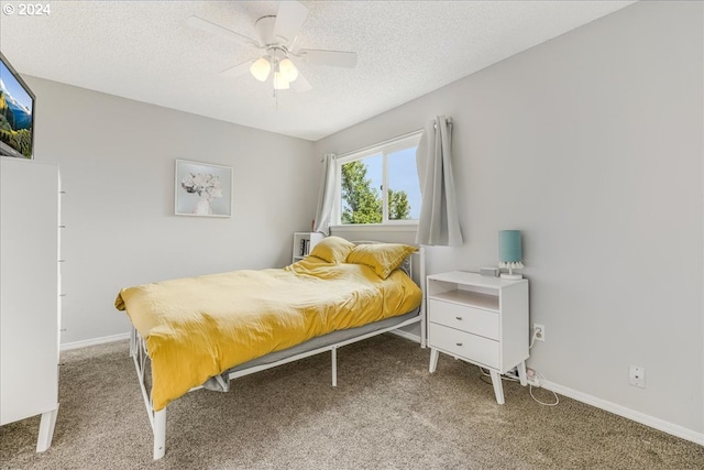 bedroom featuring a textured ceiling, carpet floors, and ceiling fan