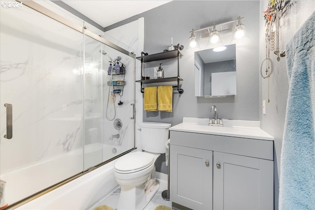 full bathroom with toilet, combined bath / shower with glass door, and vanity