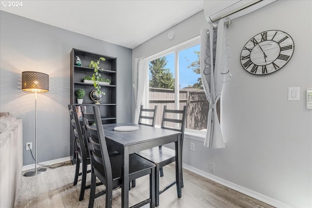 dining area with hardwood / wood-style floors and a wall mounted AC