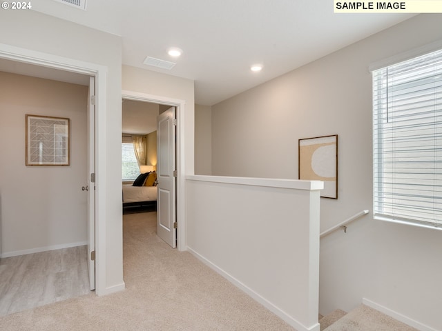 corridor with light colored carpet