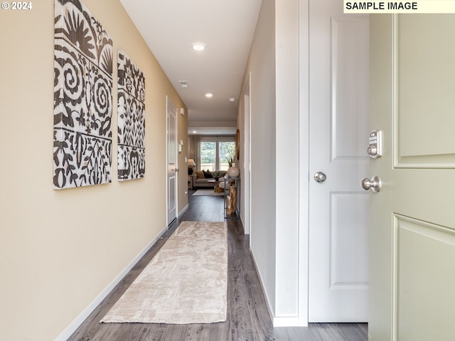 hallway with dark hardwood / wood-style flooring