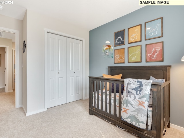 carpeted bedroom featuring a closet and a nursery area