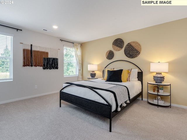 bedroom featuring light carpet