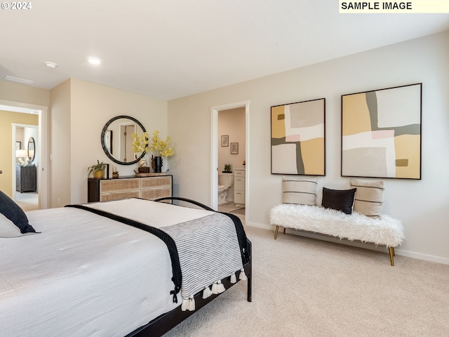 carpeted bedroom featuring ensuite bathroom