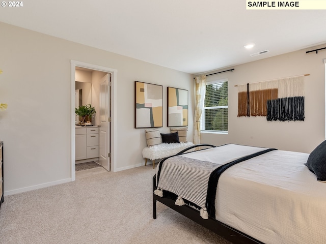 carpeted bedroom featuring ensuite bathroom