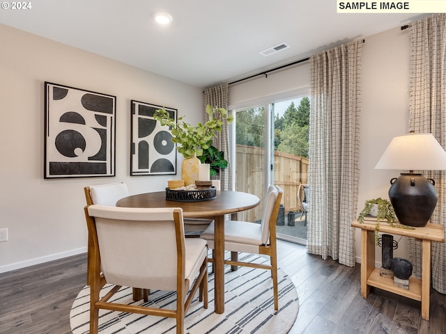 dining area with dark hardwood / wood-style floors