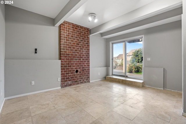 spare room featuring beamed ceiling