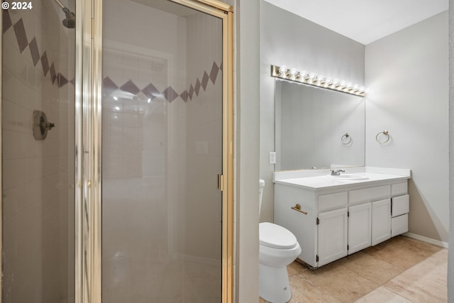 bathroom featuring tile patterned floors, vanity, toilet, and an enclosed shower