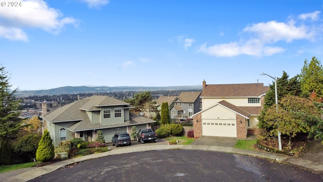 view of front of house with a mountain view and a garage