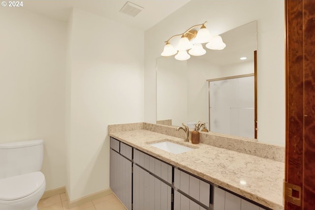 bathroom with toilet, vanity, tile patterned floors, and walk in shower