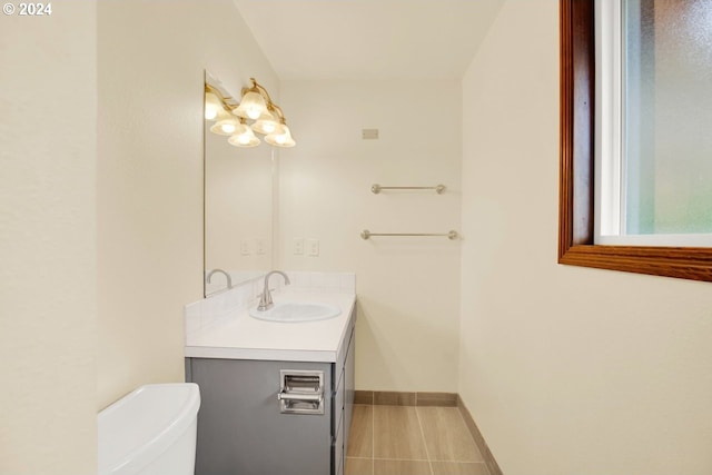 bathroom featuring tile patterned flooring, vanity, and toilet