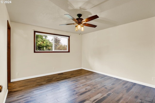 unfurnished room featuring a textured ceiling, dark hardwood / wood-style floors, and ceiling fan