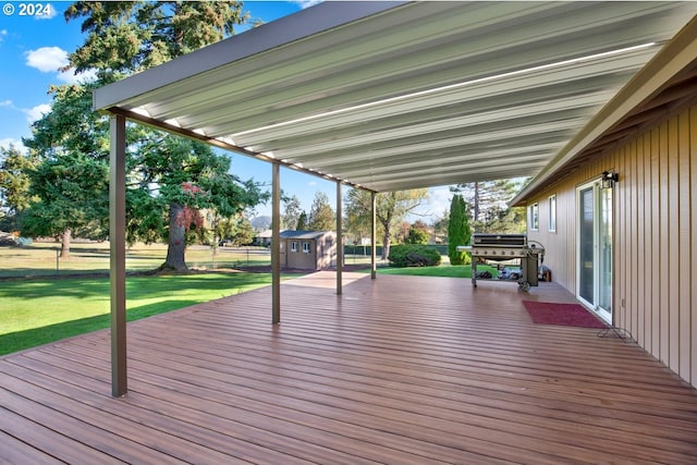 wooden terrace with a shed and a yard