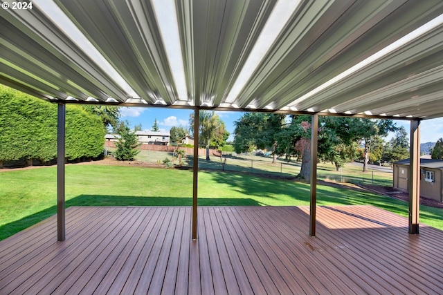 deck with a storage unit and a yard