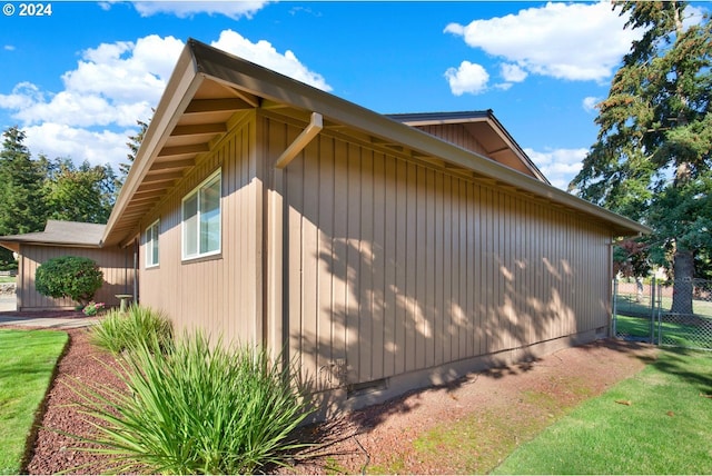 view of side of home featuring a lawn