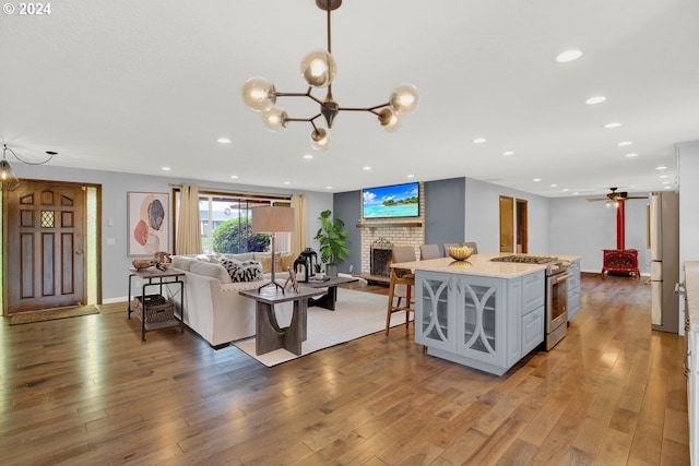 living room featuring a fireplace, dark wood-type flooring, and an inviting chandelier