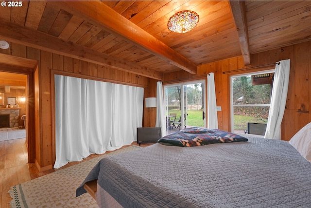 bedroom with beamed ceiling, wood walls, light hardwood / wood-style floors, access to outside, and wood ceiling