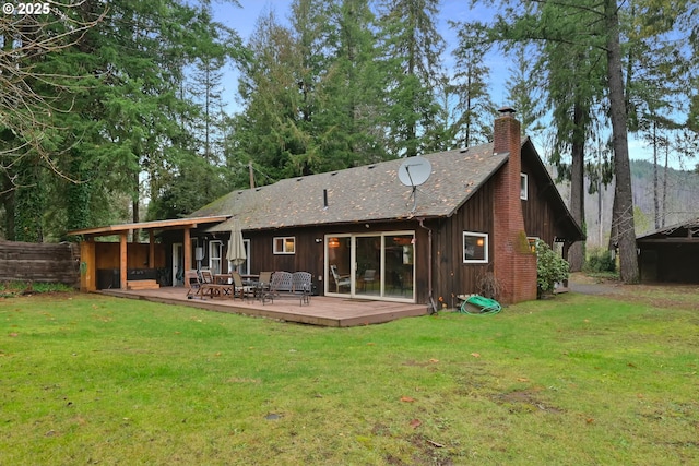 back of house with a lawn and a wooden deck