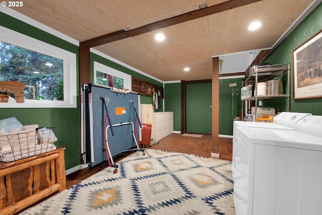 washroom with wood-type flooring, crown molding, and washing machine and clothes dryer