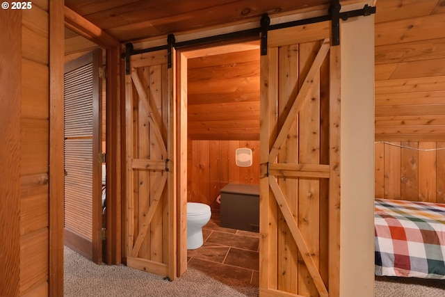 bathroom with lofted ceiling, wooden ceiling, and wooden walls