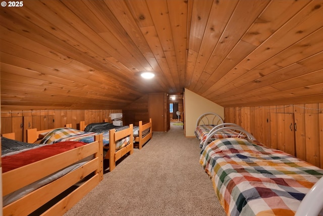 bedroom with wood walls, light colored carpet, wooden ceiling, and vaulted ceiling