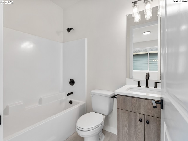 full bathroom featuring washtub / shower combination, vanity, and toilet