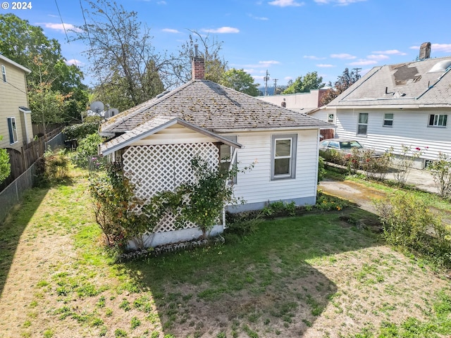 back of house with a lawn