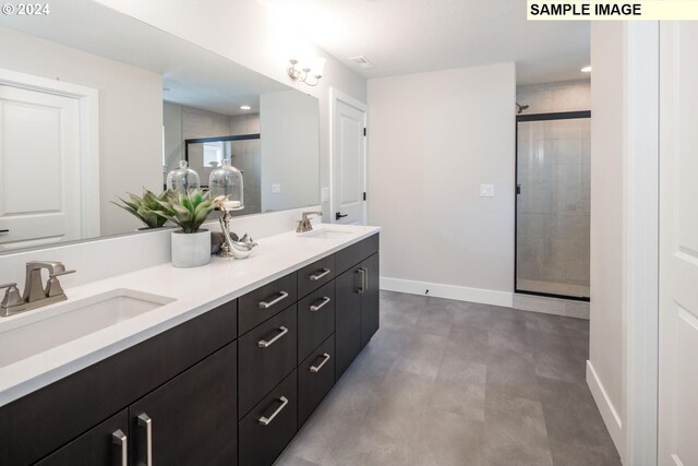 bathroom with an enclosed shower, vanity, and concrete floors