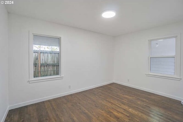 spare room featuring dark hardwood / wood-style flooring