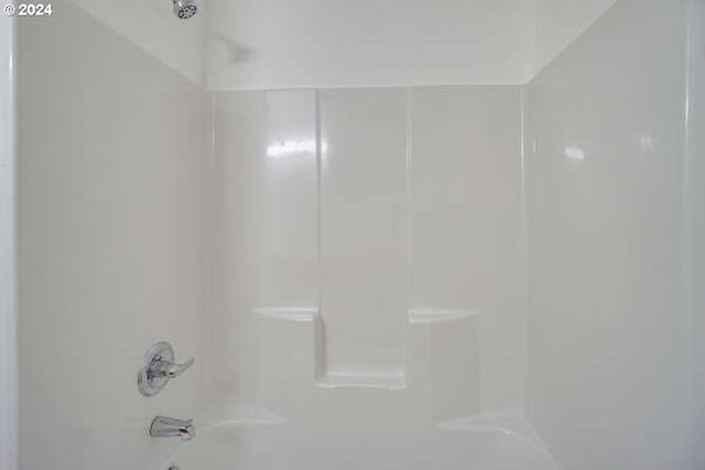 room details featuring shower / bathtub combination