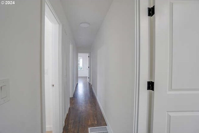 hallway with dark hardwood / wood-style flooring