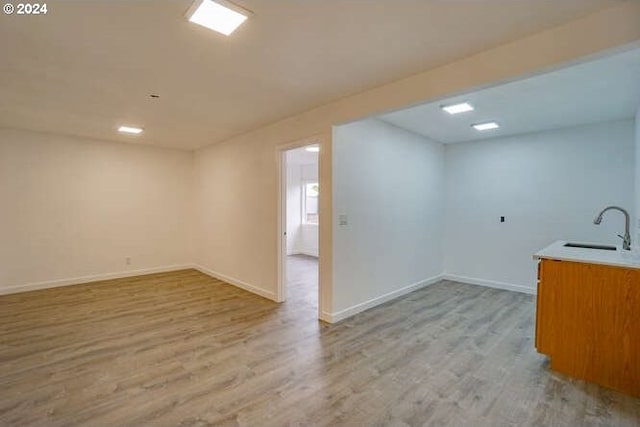 interior space with light hardwood / wood-style floors and sink