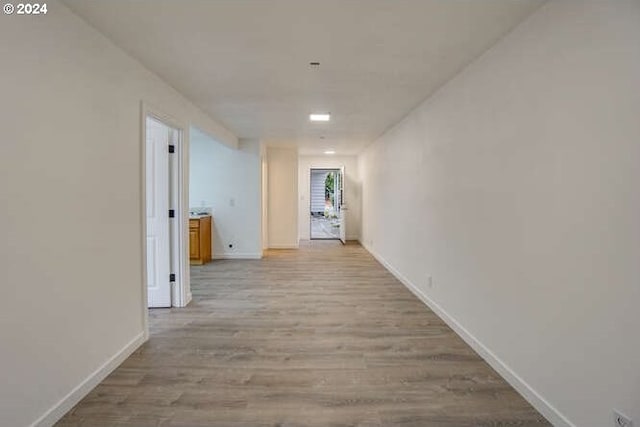 hallway with light hardwood / wood-style flooring