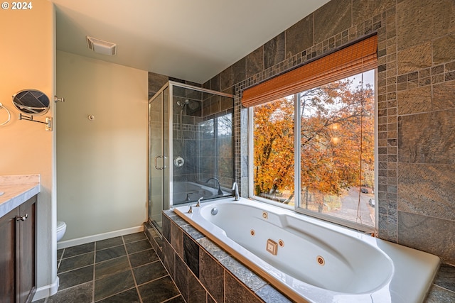 full bathroom featuring vanity, toilet, and separate shower and tub