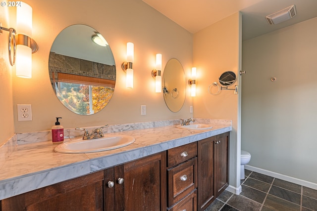 bathroom with tile patterned floors, vanity, and toilet