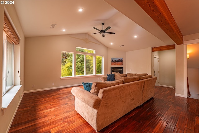 living room with dark wood-type flooring, ceiling fan, and vaulted ceiling with beams