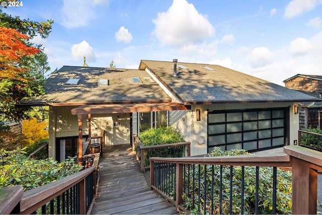 back of property featuring roof with shingles