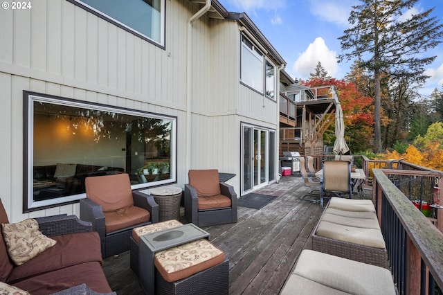 wooden deck with outdoor dining area, outdoor lounge area, and area for grilling