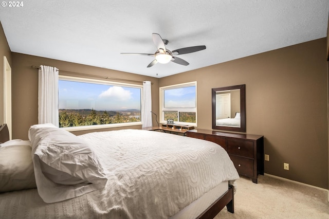 bedroom with baseboards, light colored carpet, and ceiling fan