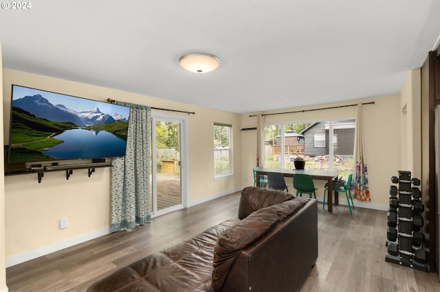 living area with wood finished floors and baseboards