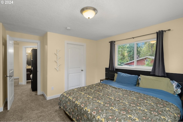 carpeted bedroom featuring a textured ceiling