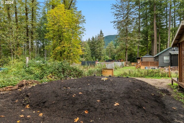 deck with area for grilling and a fire pit