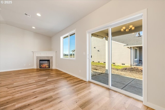 unfurnished living room with lofted ceiling and light hardwood / wood-style floors