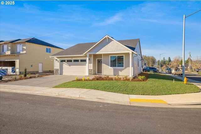 view of front of home featuring driveway, a garage, and a front yard