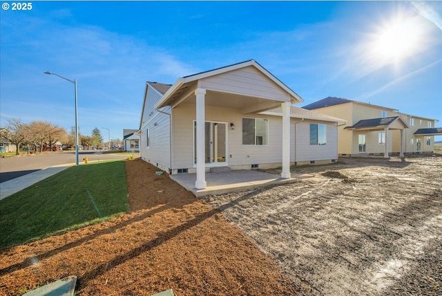 rear view of property with a patio and a yard