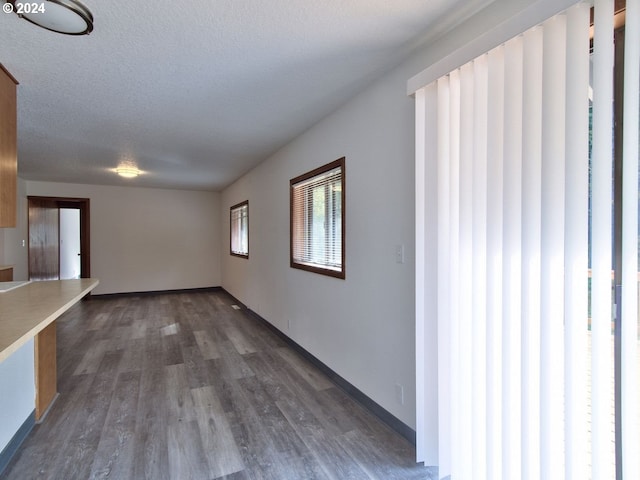 interior space with dark hardwood / wood-style flooring and a textured ceiling