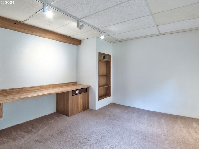 basement featuring track lighting and carpet flooring